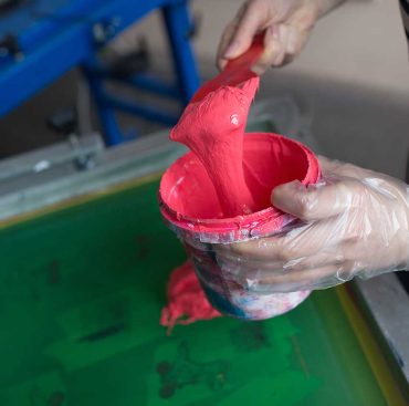 Silk screen printing. Serigraphy. Color paints and fabric. Plastisol paint.